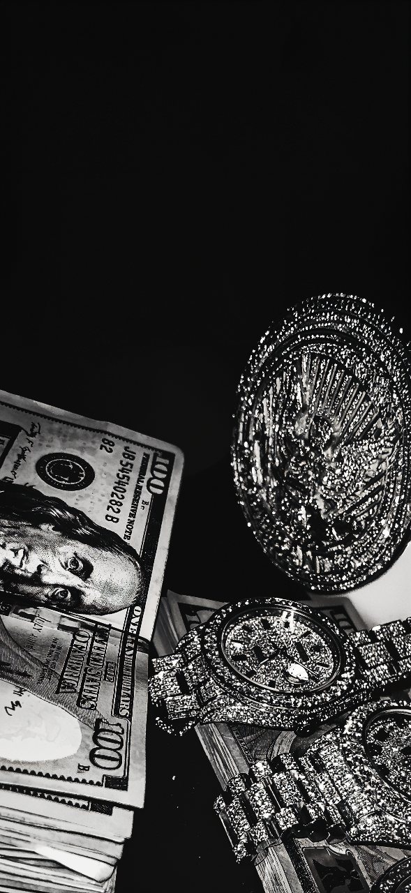 Black and white close-up of diamond-covered watches arranged over US dollar bills against a dark background.