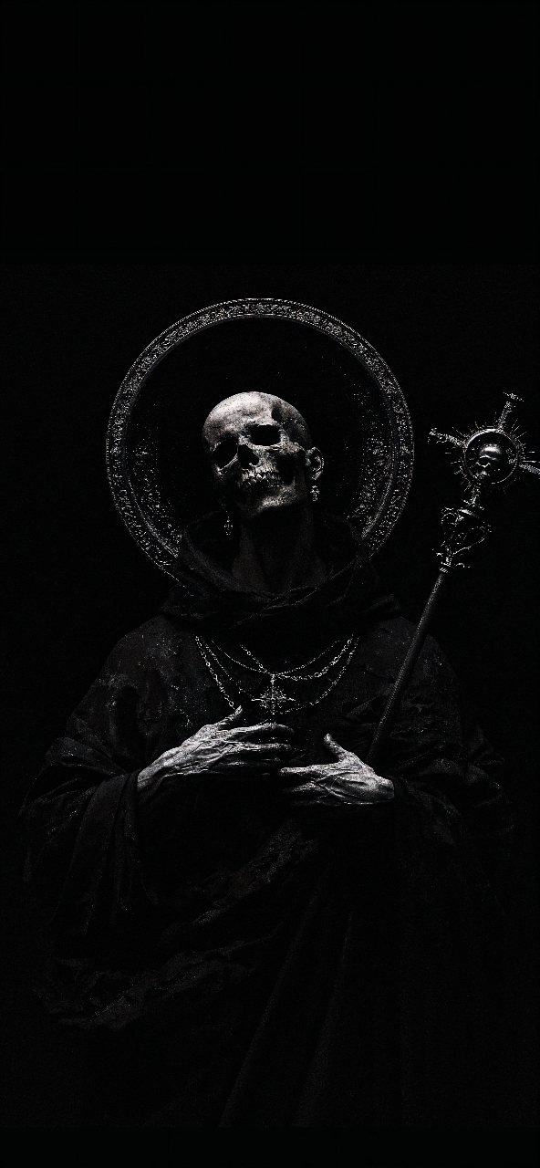 Black and white portrait of a hooded skull monk holding a staff against a nearly black background, framed by a halo-like circle.