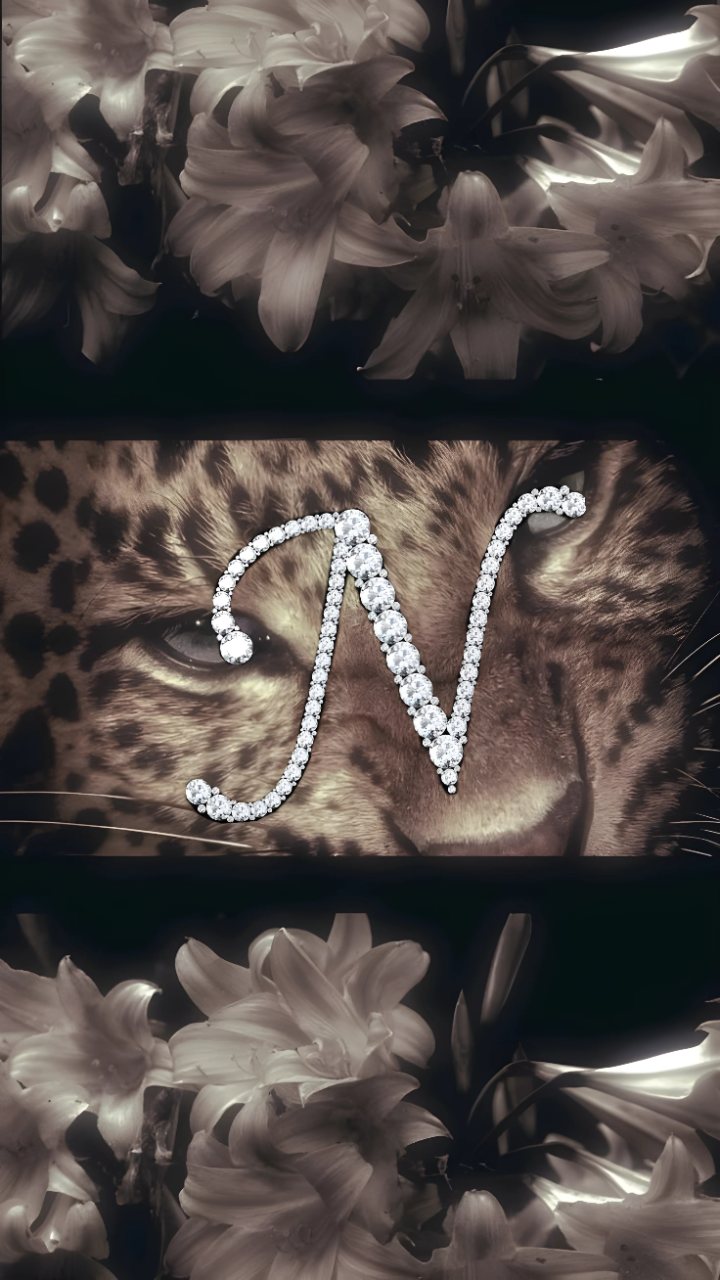 A leopard face with a sparkling diamond-studded letter N, surrounded by pale flowers against a dark monochrome background.