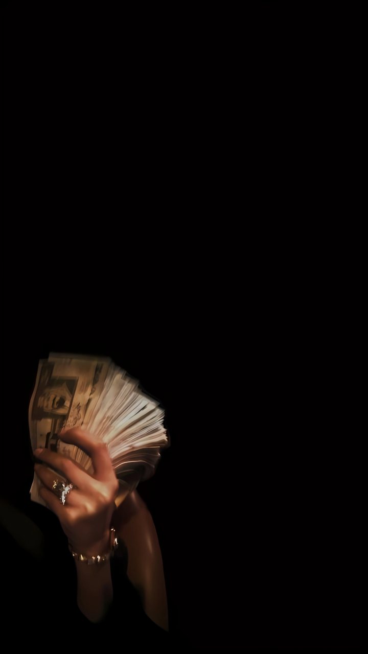 Hand Holding Stack Of Cash