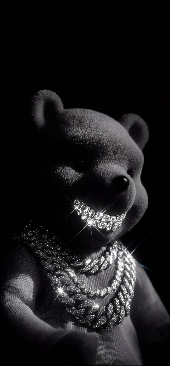 Black and white teddy bear wearing a sparkling jeweled grill and layered chains against a dark black background.