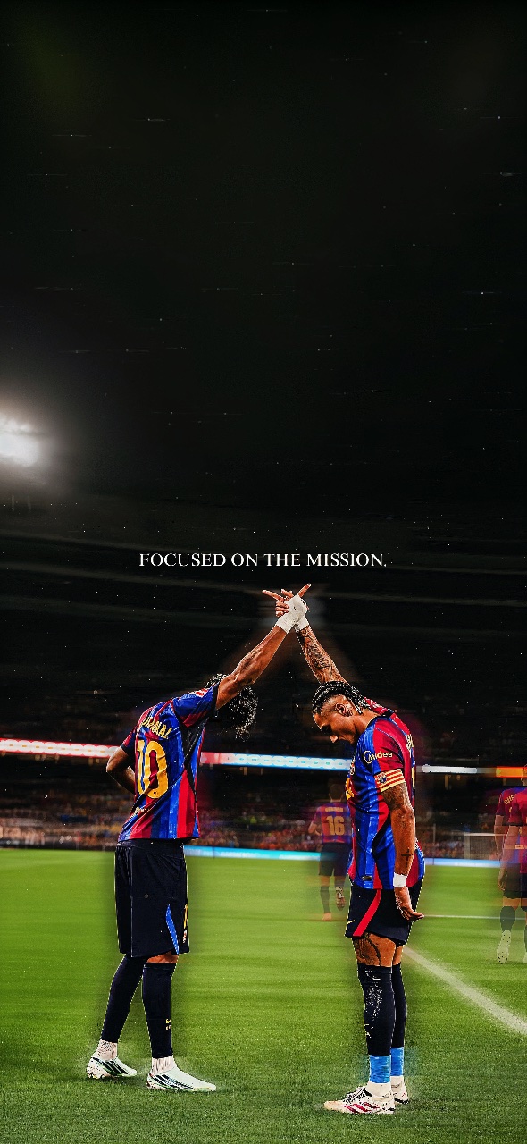 Lamine Yamal and Raphinha in Barcelona kits raise their joined hands on the pitch beneath the words “FOCUSED ON THE MISSION.”