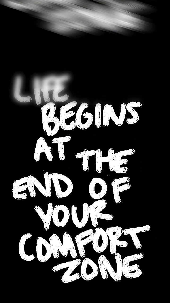 Black phone wallpaper with bold white text reading “Life begins at the end of your comfort zone” beneath a blurred gray streak.