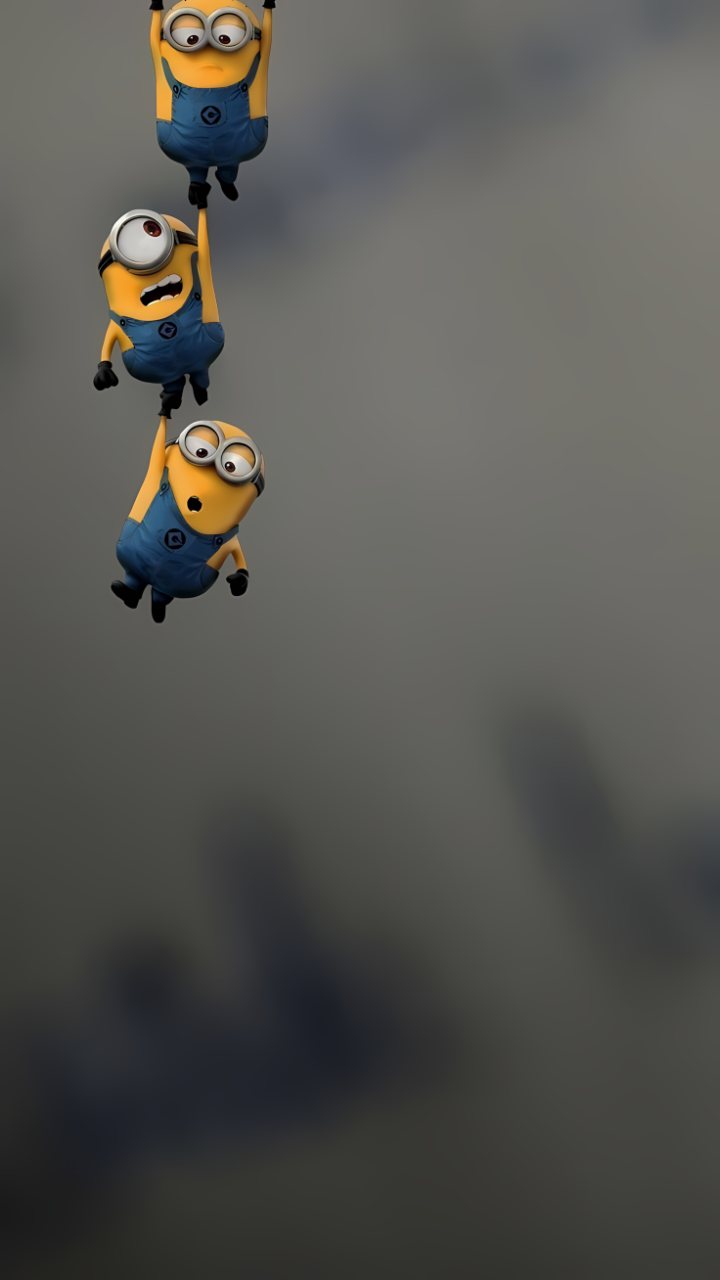 Three yellow Minions in blue overalls hang in a vertical line along the left side against a soft gray background.