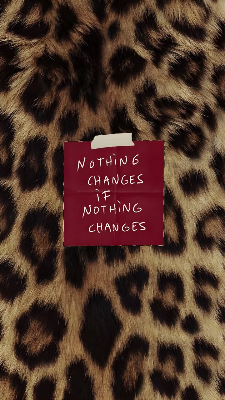 Leopard-print phone wallpaper with a red taped note displaying the handwritten quote “Nothing changes if nothing changes.”