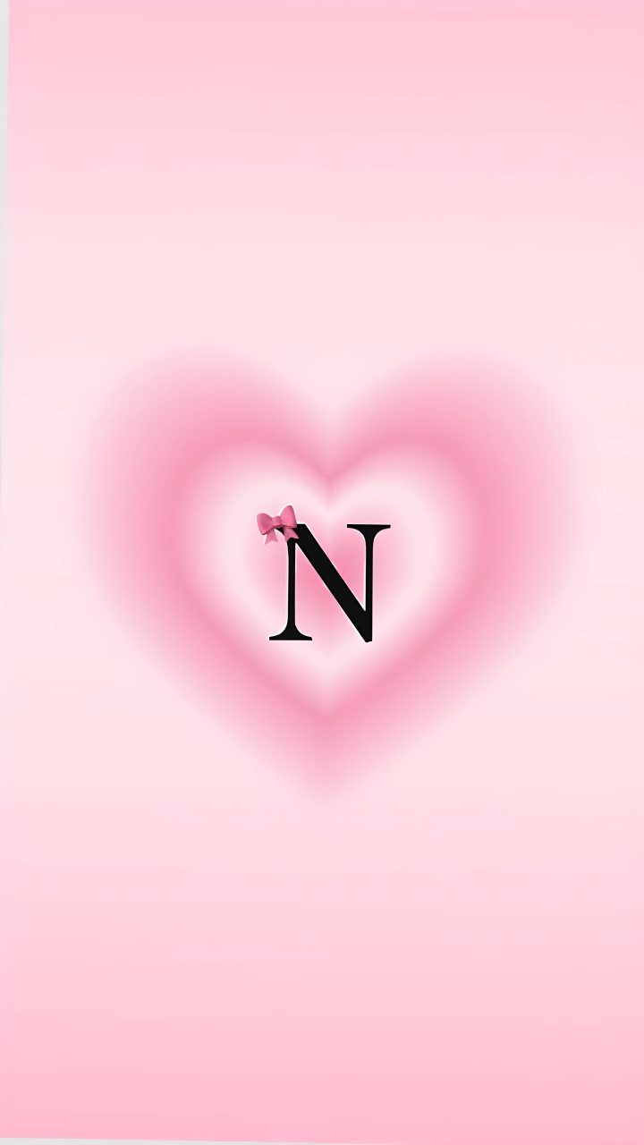 Soft pink phone wallpaper with a glowing heart, a black letter N, and a small pink bow.