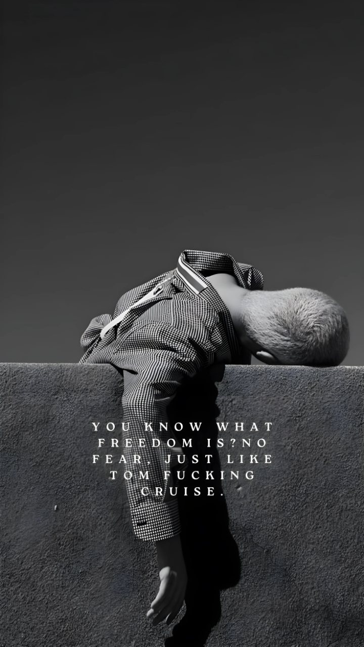 Monochrome person leaning over a concrete wall with the text, “You know what freedom is? No fear, just like Tom fucking Cruise.”